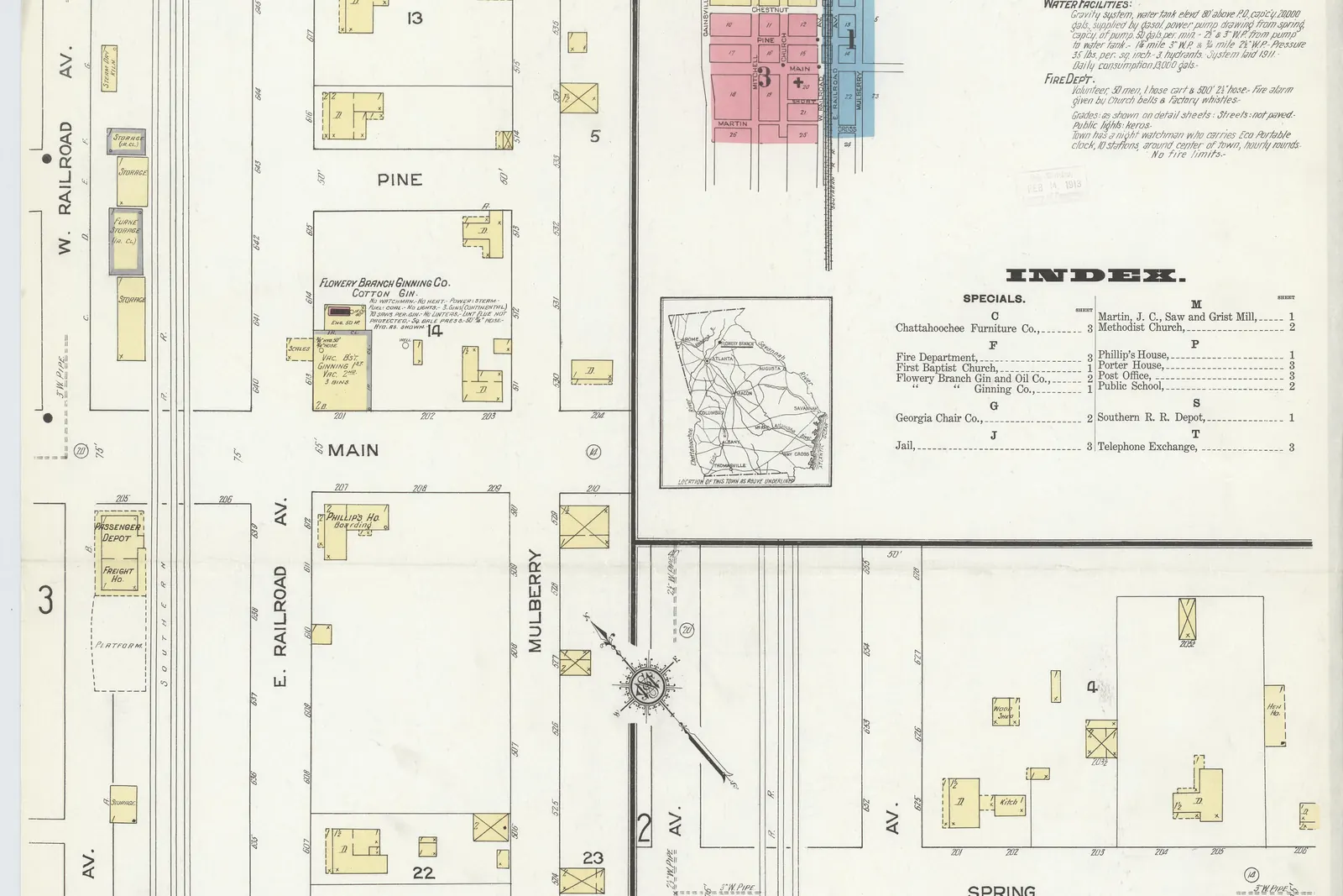 A hand-coloured 1912 fire-insurance map sheet with a Sanborn Map Company seal reading 'Flowery Branch, Georgia, 1912' and an index at upper right; parallel rail lines run down the left side between streets labelled W. Railroad Av. and E. Railroad Av., crossed by Chestnut, Pine and Main, with a building marked as a passenger depot beside the tracks and small yellow building footprints on numbered blocks.